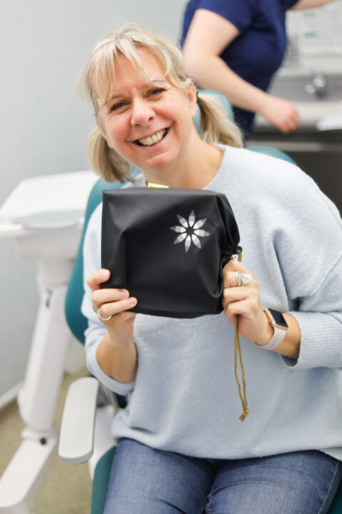 A Park Lane clinician presenting a clear Invisalign aligner